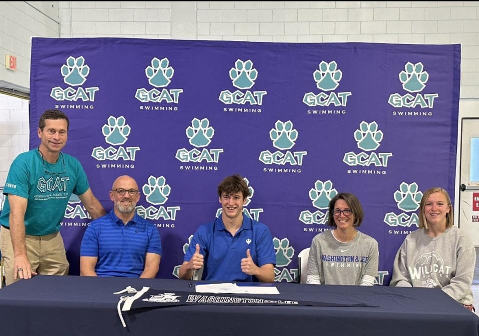 Aiden Gray of Richmond Hill High and the GCAT Swim Club with his family and coach Bill Forrester as he signed with Washington and Lee University Thursday.