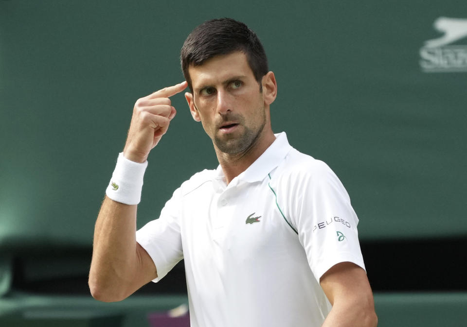 Serbia's Novak Djokovic gestures during the men's singles final match against Italy's Matteo Berrettini on day thirteen of the Wimbledon Tennis Championships in London, Sunday, July 11, 2021. (AP Photo/Alberto Pezzali)