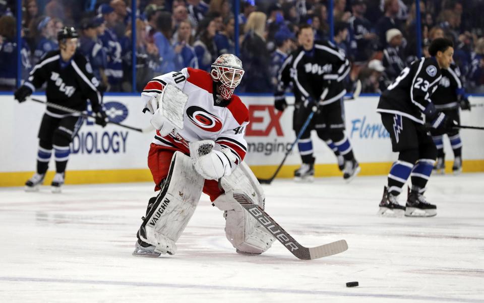 Carolina Hurricanes equipment manager Jorge Alves warms up after signing a contract to dress as an emergency backup for the team's NHL hockey game against the Tampa Bay Lightning on Saturday, Dec. 31, 2016, in Tampa, Fla. (AP Photo/Mike Carlson)