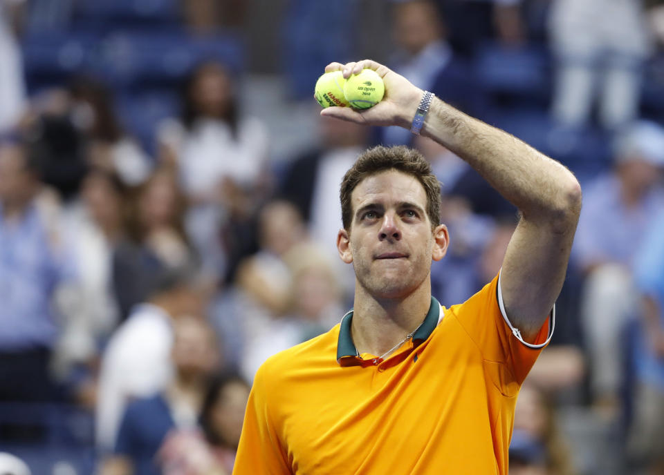 Juan Martin del Potro, of Argentina, hit tennis ball to fans following a match against Rafael Nadal, of Spain, during the semifinals of the U.S. Open tennis tournament, Friday, Sept. 7, 2018, in New York. Nadal retired from the match. (AP Photo/Adam Hunger)