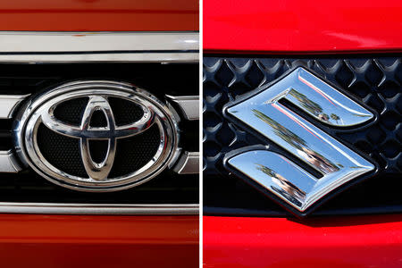 The logos of Toyota (R) and Suzuki are pictured. REUTERS/Erik De Castro/Mike Blake