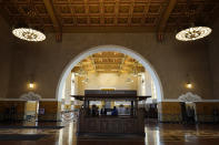 The interior of Union Station in Los Angeles appears on March 23, 2021. The Oscars are headed to the historic site for the first time this year. With wide open spaces and 65-foot high ceilings, it’s ideal for a big crew and cameras. It’s been used in car commercials, reality shows and procedurals. But its beamed ceilings, Spanish tile floors and regal bronze chandeliers really shine in cinema where it’s played train stations, banks, police stations, clubs and airports. (AP Photo/Chris Pizzello)