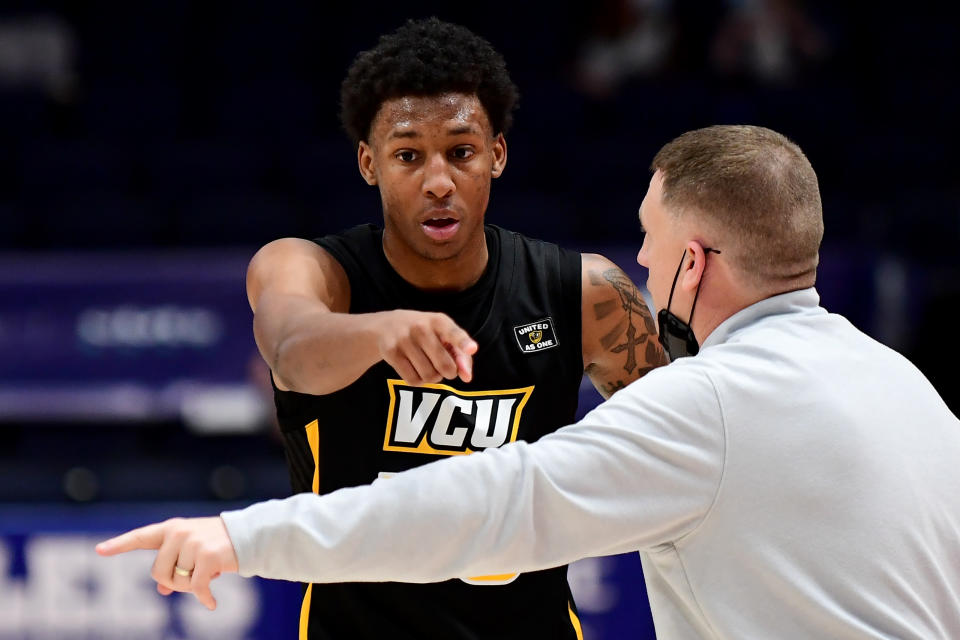 Virginia Commonwealth coach Mike Rhoades talks to Josh Banks during a game on March 14. (Emilee Chinn/Getty Images)