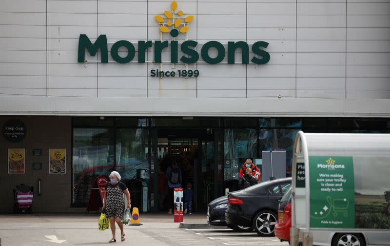 FILE PHOTO: A customer carries a shopping bag outside a Morrisons supermarket in New Brighton