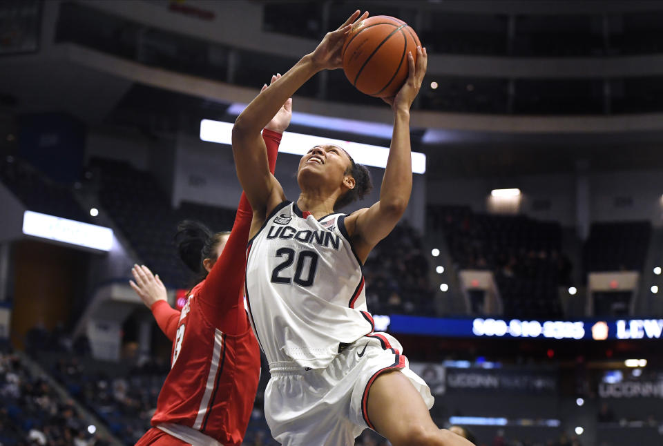 Connecticut's Olivia Nelson-Ododa is fouled by St. John's Danielle Cosgrove, left, during the second half of an NCAA college basketball game Friday, Feb. 25, 2022, in Hartford, Conn. (AP Photo/Jessica Hill)