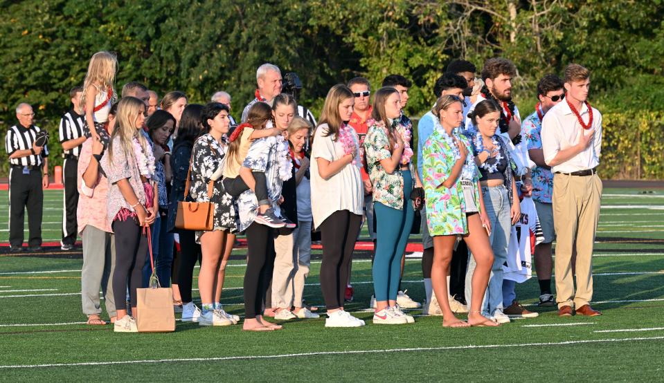 Sam Needham's family stands for a moment of silence and the national anthem before Barnstable's game against Brockton on Friday.  Sam died recently in an accident in Marstons Mills in which his motorcycle was struck by an alleged drunk driver.