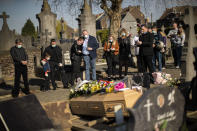 Relatives of Margodt Genevieve, who died due to Covid-19, grieve during her funeral ceremony at the Montignies cemetery in Charleroi, Belgium, Wednesday, April 8, 2020. The new coronavirus causes mild or moderate symptoms for most people, but for some, especially older adults and people with existing health problems, it can cause more severe illness or death. (AP Photo/Francisco Seco)
