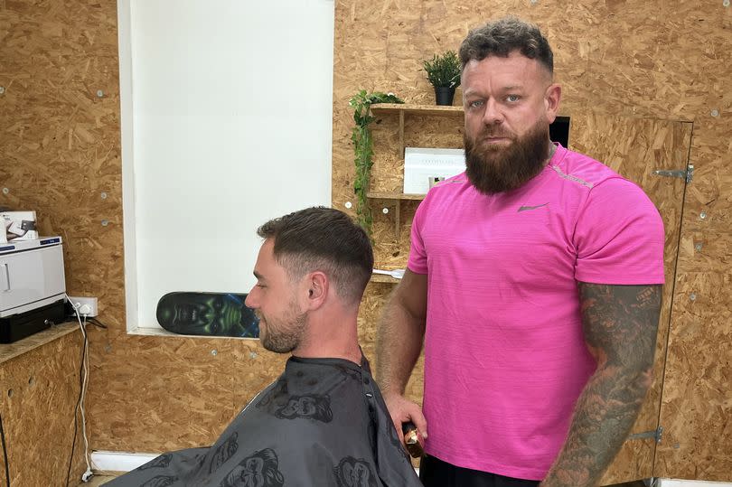 Sam Mac (right), who runs Sterling Barbers in Saltney, classes himself as English