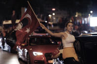 A supporter of Ekrem Imamoglu, the candidate of Turkey's secular opposition Republican People's Party, CHP, holds a poster with modern Turkey's founder Mustafa Kemal Ataturk as she celebrates in central Istanbul, late Sunday, June 23, 2019. The opposition candidate for mayor of Istanbul celebrated a landmark win Sunday in a closely watched repeat election that ended weeks of political tension and broke the long hold President Recep Tayyip Erdogan's party had on leading Turkey's largest city. (AP Photo/Burhan Ozbilici)