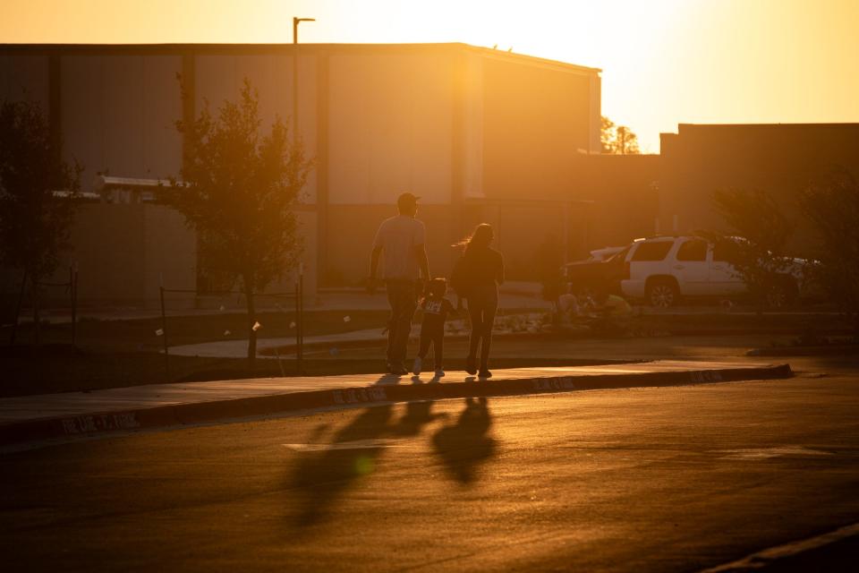 Parents walk students to Cullen Place Elementary on the first day of school, Wednesday, Aug. 9, 2023, in Corpus Christi, Texas.