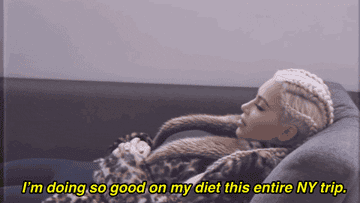Kim Kardashian lying on a couch in a leopard coat, the caption says 'I'm doing so good on my diet this entire NY trip'