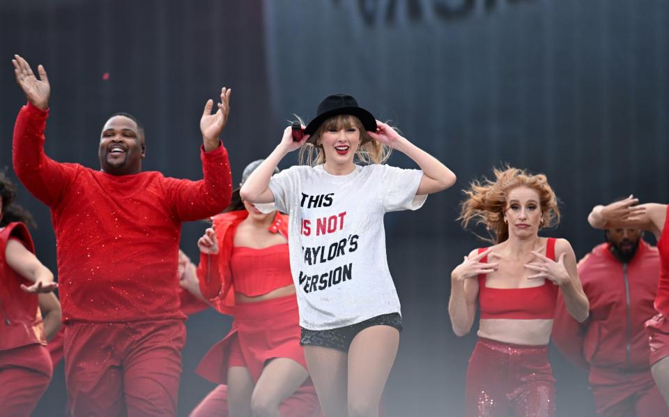During her performance of 22, Swift storms down the stage and hands her black trilby to a member of the audience