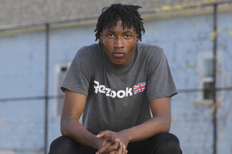 Jamari Shaw, 16, poses for a portrait in his East side neighborhood Thursday, May 11, 2023, in Buffalo, N.Y. Shaw is one of many young people who are still nervous in their surroundings since last years racist mass shooting at Tops Market. (AP Photo/Jeffrey T. Barnes)