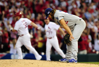 St. Louis Cardinals left fielder Matt Holliday (7) reacts after he hits a  three run home run in the seventh inning against the Los Angeles Dodgers in  game one of the 2014