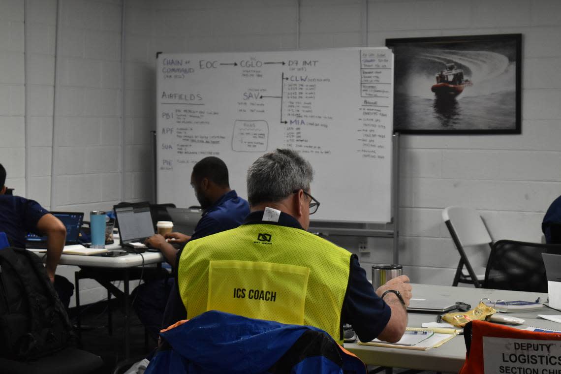 Staff works at a makeshift command center ahead of Hurricane Ian at the U.S. Coast Guard Air Station in Opa-locka on Tuesday, Sept. 27, 2022. The Coast Guard is prepared to dispatch units to respond and assist other local, state and federal agencies.