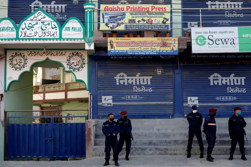 Nepalese police officers stand guard in front of a mosque as locals protest against Indonesians taking shelter at the mosque, amid fear of outsiders spreading coronavirus disease (COVID-19), at Jame Masjid in Imadol, Lalitpur