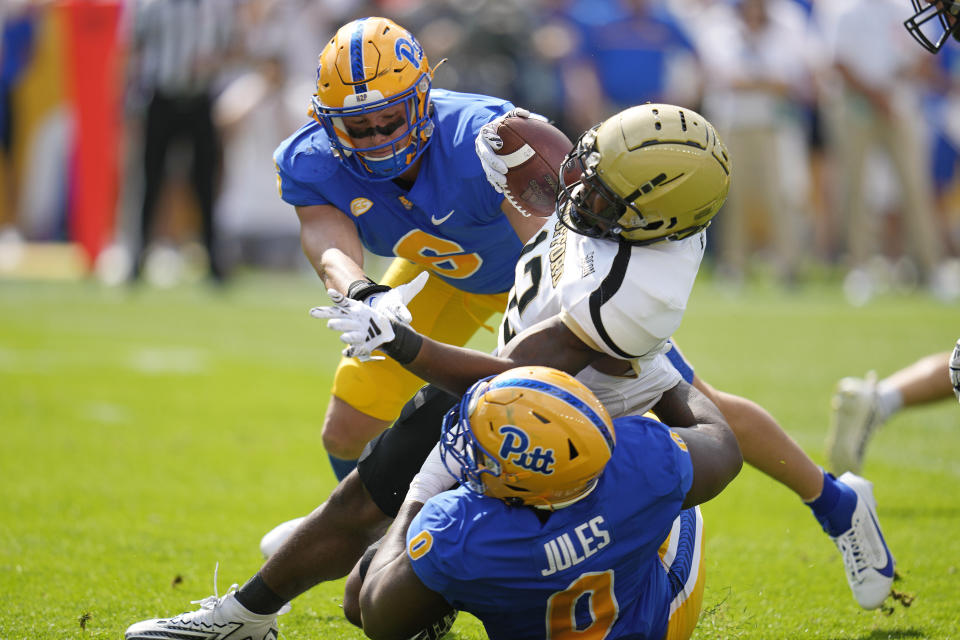 Wofford running back Ryan Ingram, center, is tackled by Pittsburgh defensive lineman Deandre Jules (0) and defensive lineman Nate Temple (6) during the first half of an NCAA college football game in Pittsburgh Saturday, Sept. 2, 2023. (AP Photo/Gene J. Puskar)