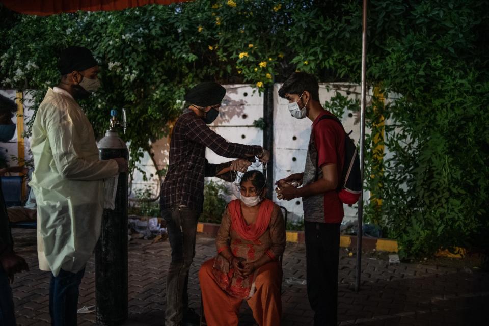 <p>Volunteers treat patients at a makeshift clinic in New Delhi</p> (Getty Images)