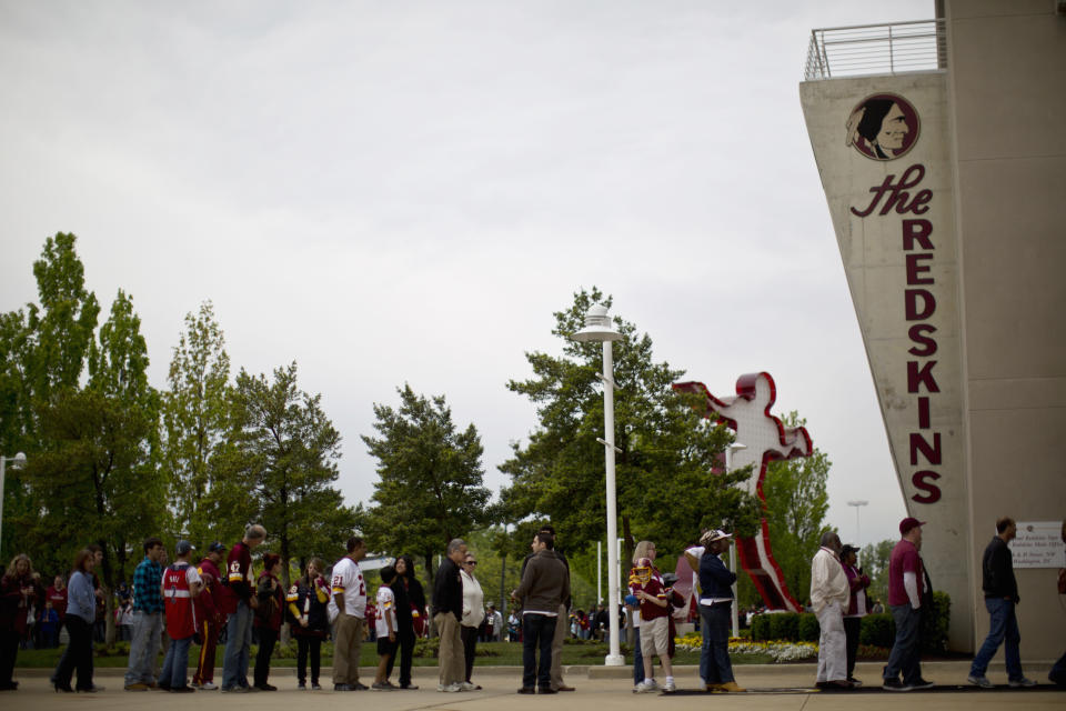 Redskin fans wait in line outside the FedEx Field stadium before the start of a draft day party in Landover, Maryland April 28, 2012. The party was held to celebrate this year's draft picks, including first round draft pick QB Robert Griffin III to the Washington Redskins. REUTERS/Benjamin Myers   (UNITED STATES - Tags: SPORT FOOTBALL)