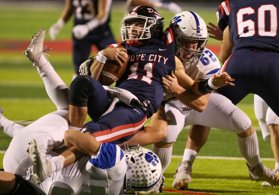 Hilliard Davidson defenders David Stump (8) and Dominic Conley (62) sack Grove City’s Matthew Papas (11) during a first-round playoff game Oct. 28.