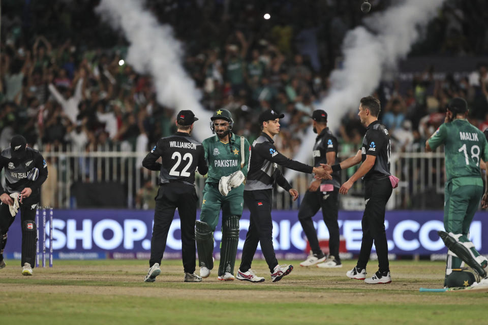 Pakistan's Asif Ali, center, and Pakistan's Shoaib Malik greet New Zealand's players at the end of the Cricket Twenty20 World Cup match between New Zealand and Pakistan in Sharjah, UAE, Tuesday, Oct. 26, 2021. (AP Photo/Aijaz Rahi)