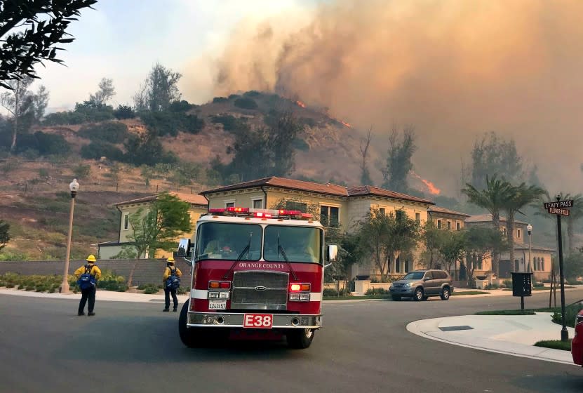 Firefighters do structure protection for homes in Irvine as the Silverado fire continues to burn