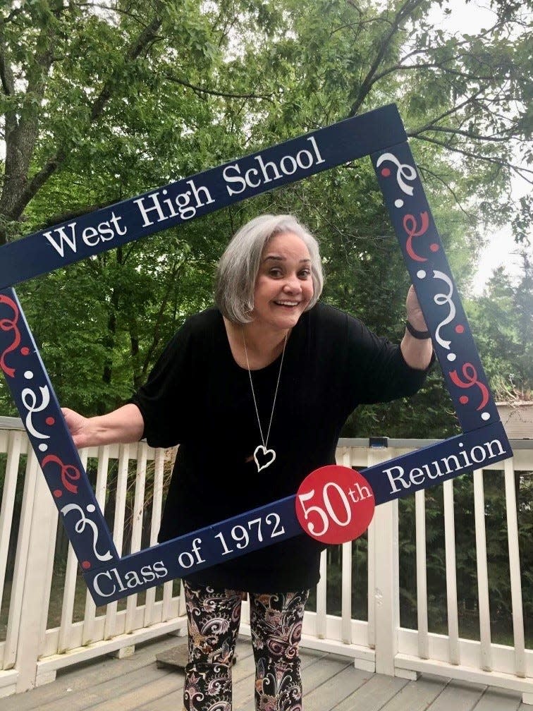 Lynn Ballard Chapman, now of Chattanooga, hams it up with the special picture frame at the West High Class of 1972 reunion on June 18, 2022.