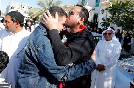 Ali Al-Ekri (R) kisses his family member as he is welcomed home after completing his five-year sentence, in Manama, Bahrain March 10, 2017. REUTERS/Hamad I Mohammed