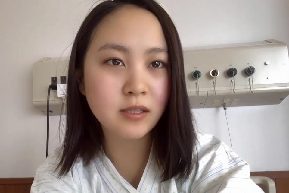 In this April 15, 2020, image made from the Youtube account of Arisa Kadono, she speaks to her smartphone video at a hospital, in Himeji, western Japan. Soon after Kadono tested positive for the coronavirus and hospitalized in early April, her friends let her know that groundless rumors were circulating.(Arisa Kadono via AP)