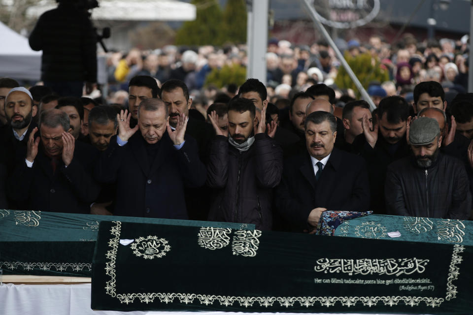 Turkey's President Recep Tayyip Erdogan, center left, joins hundreds of mourners who attend the funeral prayers for nine members of Alemdar family killed in a collapsed apartment building, in Istanbul, Saturday, Feb. 9, 2019. Erdogan says there are "many lessons to learn" from the collapse of a residential building in Istanbul where at least 17 people have died. (AP Photo/Emrah Gurel)