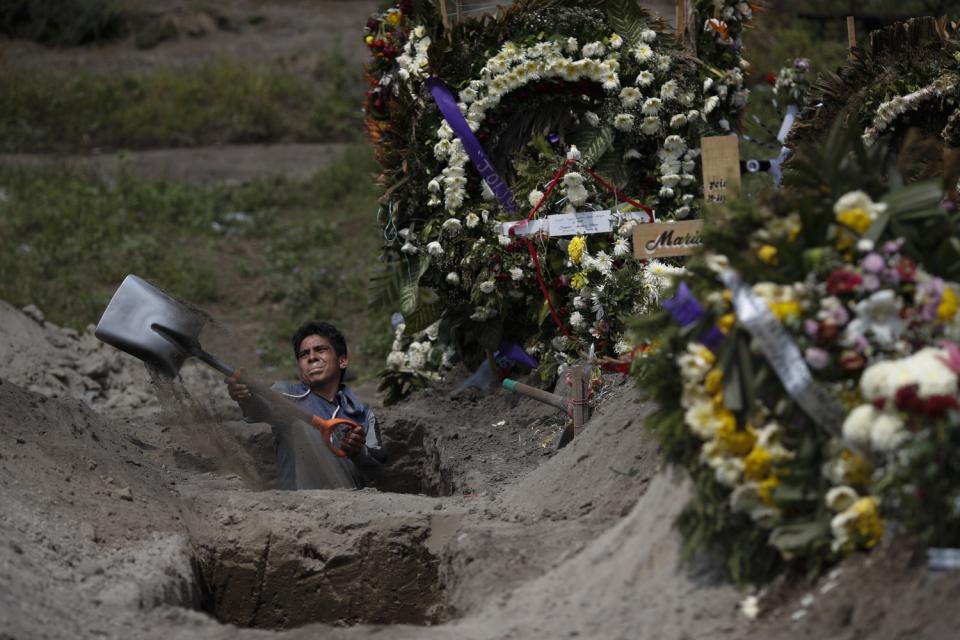 A cemetery worker digs a grave in Mexico City