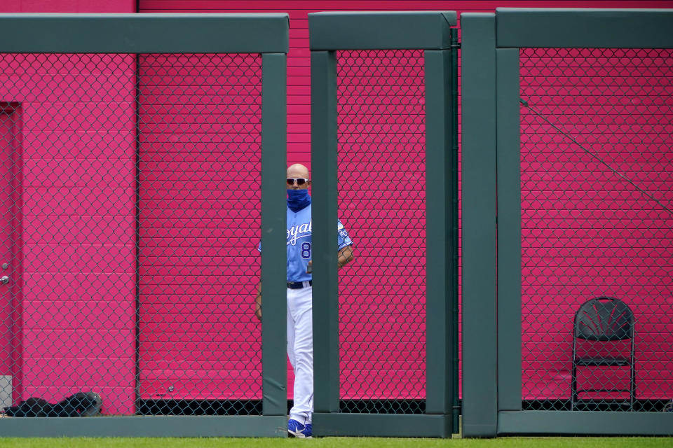 Kansas City Royals bullpen catcher closes the bullpen gate during the third inning of a baseball game against the Chicago White Sox Sunday, Aug. 2, 2020, in Kansas City, Mo. (AP Photo/Charlie Riedel)