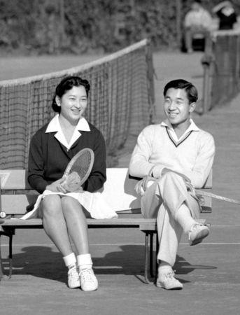 Japan's Crown Prince Akihito talks with Michiko Shoda as they enjoy tennis at Tokyo Lawn Tennis Club in Tokyo, Japan December 6, 1958, in this photo released by Kyodo. Mandatory credit Kyodo/via REUTERS