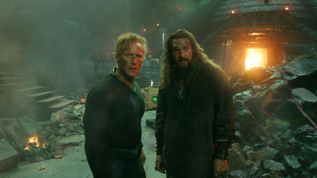  Orm and Aquaman stand in front of some wreckage in Aquaman 2. 