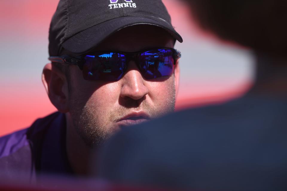 Wylie assistant coach Adam Cherry talks to Marshall McPherson and Carly Bontke during their first-round mixed doubles match the Region I-5A tournament April 10 in Lubbock.