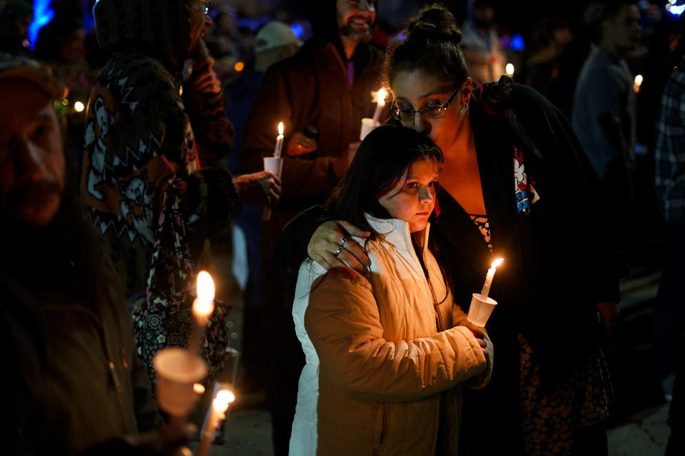 People gather at a vigil for the victims of Wednesday's mass shootings, Sunday, Oct. 29, 2023, outside the Basilica of Saints Peter and Paul in Lewiston, Maine. (AP Photo/Matt Rourke)