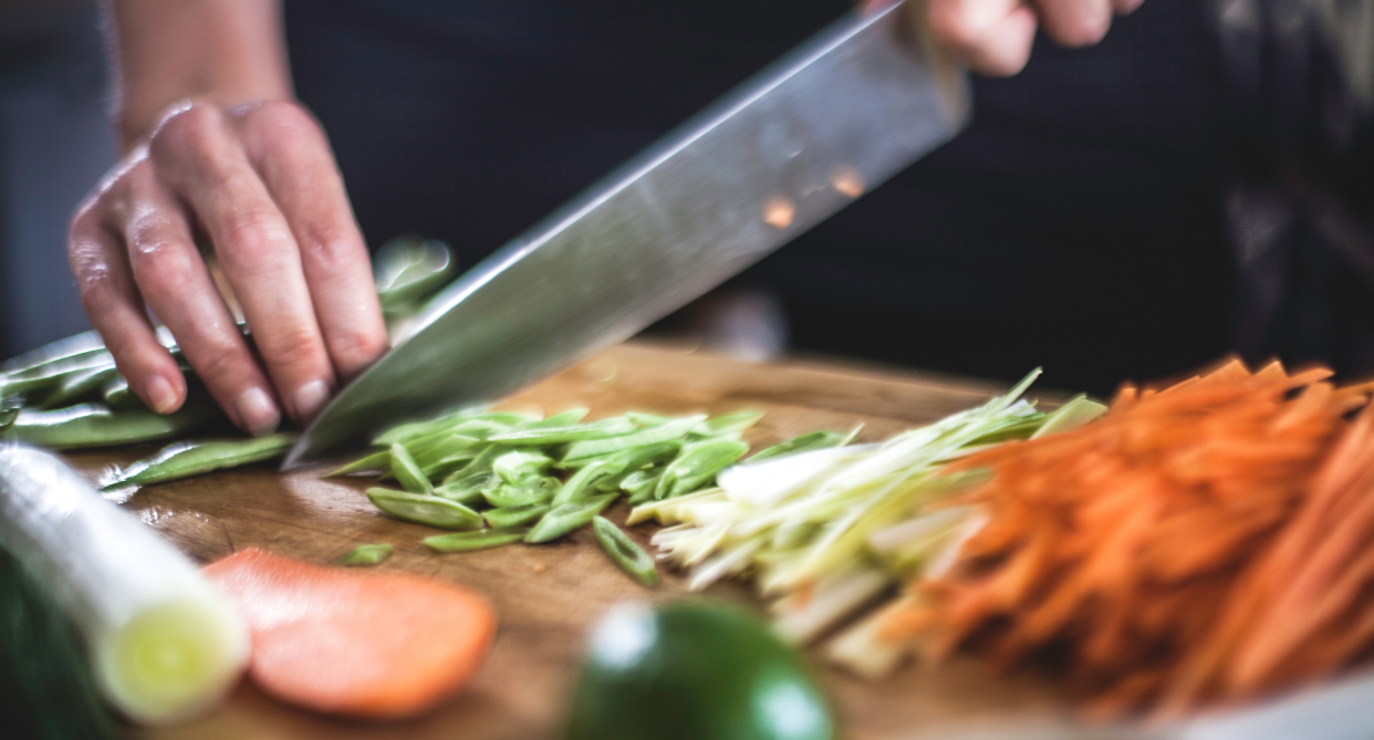 hand holding chef's knife on cutting board cutting peppers, carrots, vegetables, amazon canada chef knife deal of the day sale
