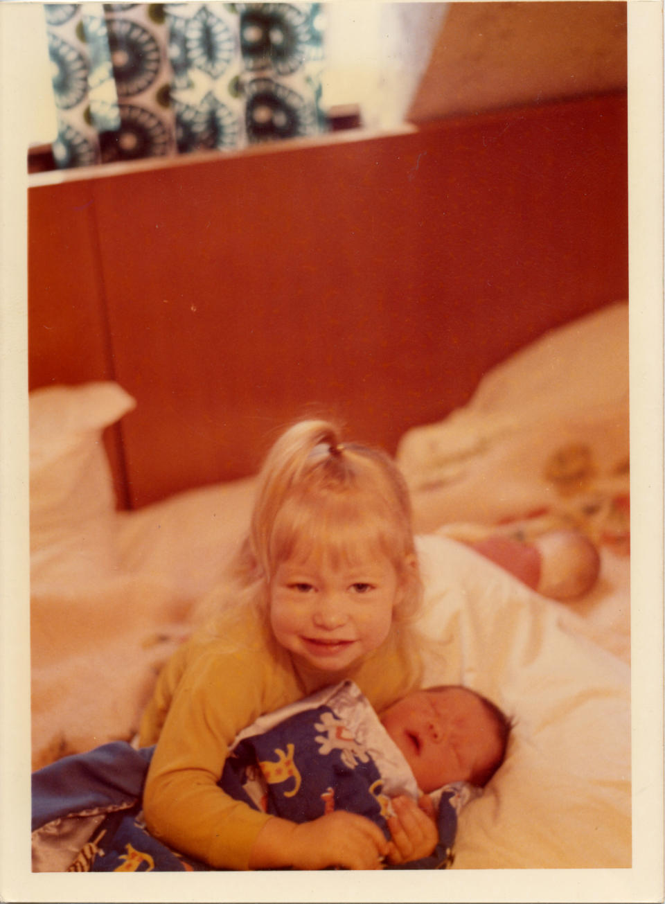 Condie holds her little sister as a baby. (Courtesy Ganel-Lyn Condie)