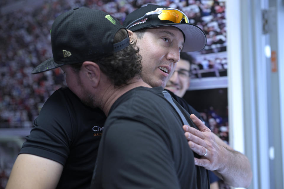 Kurt Busch, front, gets a hug from his brother, Kyle Busch, after announcing his retirement before a NASCAR Cup Series auto race at Daytona International Speedway, Saturday, Aug. 26, 2023, in Daytona Beach, Fla. (AP Photo/Phelan M. Ebenhack)