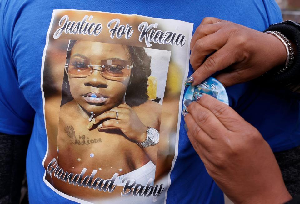 Buttons with a picture of Kiazia Miller are pinned on others shortly before a memorial was held at her home in Detroit, Saturday, Nov. 19, 2022. Miller who was having a mental health crisis at the time she was shot and killed by Detroit Police officers. Two officers and one supervisor were later suspended pending a review.