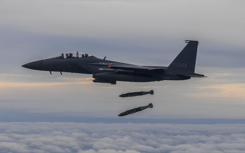 A South Korean F-15K fighter fires two bombs into an island target in response to North Korea's ballistic missile launch - Getty Images