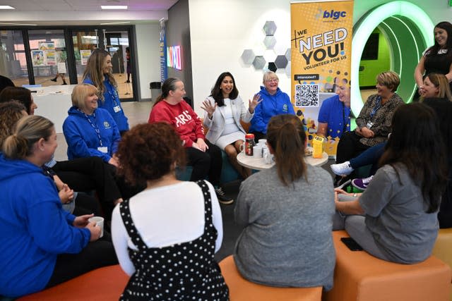 Home Secretary Suella Braverman speaks to volunteers during a visit to Bolton Lads and Girls Club in Bolton, Greater Manchester