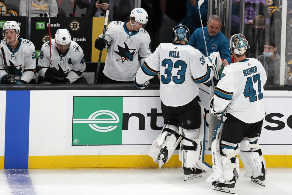 San Jose Sharks' Adin Hill (33) leaves the ice to be replaced by James Reimer (47) during the second period of an NHL hockey game against the Boston Bruins, Sunday, Oct. 24, 2021, in Boston. (AP Photo/Michael Dwyer)