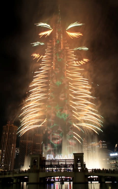 Fireworks explode around the Burj Khalifa, the tallest building in the world, during New Year celebrations in Dubai - Credit: Reuters