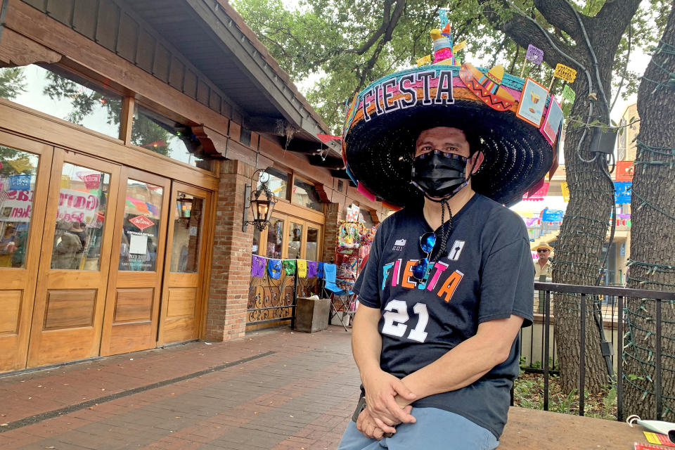 Michael Perez of San Antonio made a hat for Fiesta festooned with cards similar to those found in the Mexican bingo like game, Loteria, but with symbols of the coronavirus crisis. (Suzanne Gamboa / NBC News)