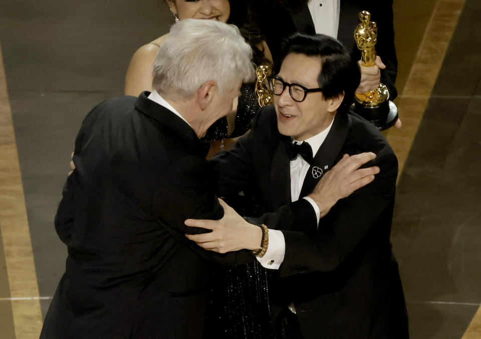 HOLLYWOOD, CALIFORNIA - MARCH 12: Ke Huy Quan (R) accepts the award for Best Picture for 