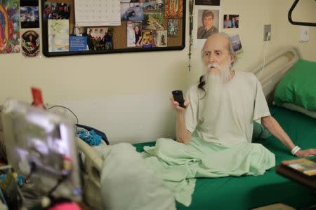 Inmate Michael Patrick Rodriguez, 62, who has skin cancer watches a meditation video in the hospice at the California Medical Facility prison in Vacaville, California, U.S., May 22, 2018. "I'm going to beat this thing - get out. I'm going to beat this cancer," Rodriguez said. "They're helpful (the pastoral care service inmates). They're doing everything we want that we couldn't do before... One guy that comes in here is reading a Harry Potter book for me." REUTERS/Lucy Nicholson