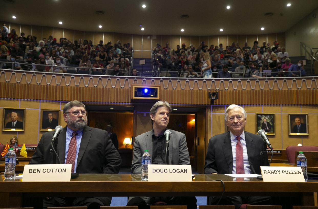 Presenters of the report on the election audit, from left, Ben Cotton, the founder of CyFIR, Doug Logan, the CEO of Cyber Ninjas and Randy Pullen, the audit spokesman, look on before the start of the presentation to the Arizona State Senate in the Senate chambers of the Arizona Capitol in Phoenix on Sept. 24, 2021.