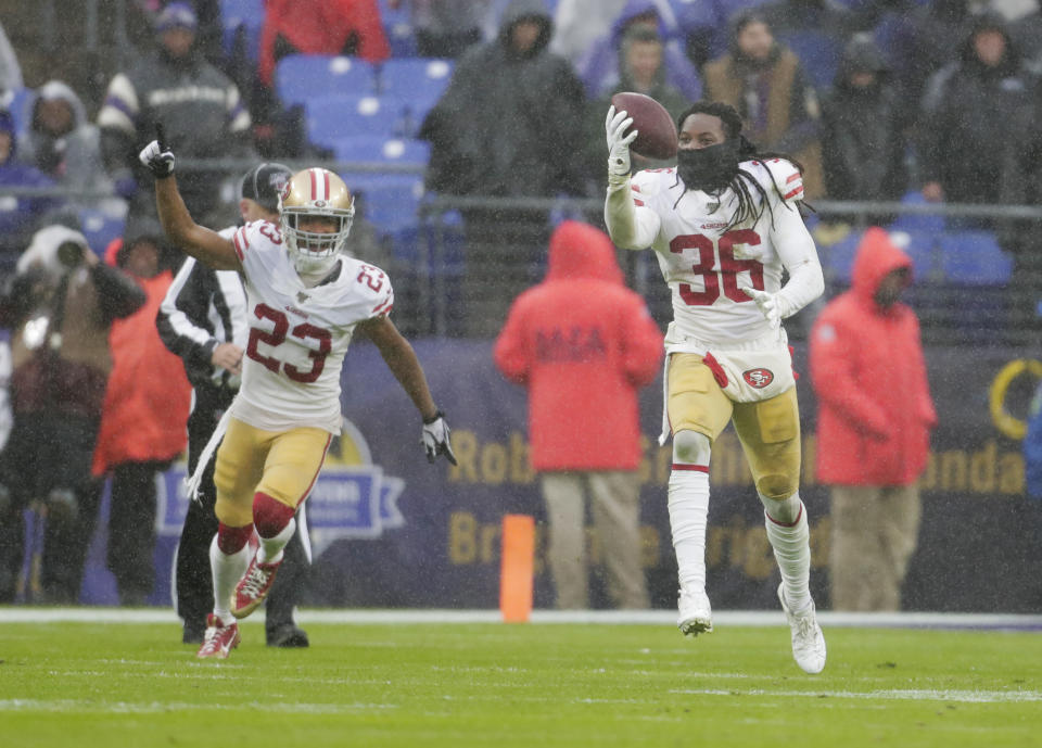 San Francisco 49ers defensive back Marcell Harris (36) runs after to recovering the ball from Baltimore Ravens quarterback Lamar Jackson who fumble it in the second half of an NFL football game, Sunday, Dec. 1, 2019, in Baltimore, Md. With Harris is teammate cornerback Ahkello Witherspoon (23). (AP Photo/Julio Cortez)