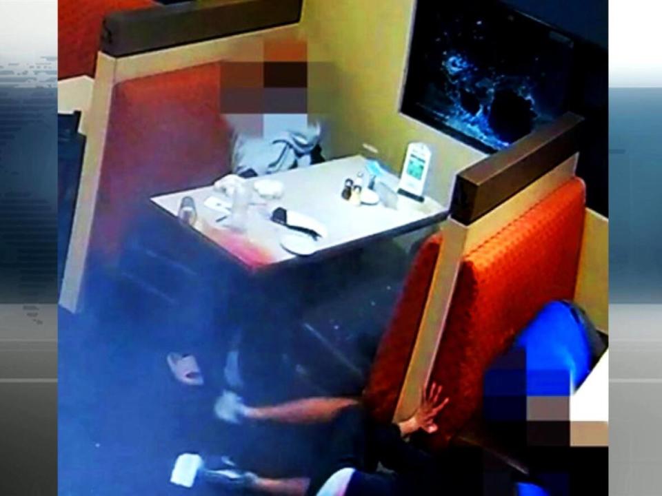 Edmonton police released this image, taken in the moments after an assailant fired multiple gunshots through a restaurant window at a man and his family. (Submitted by Edmonton Police Service - image credit)